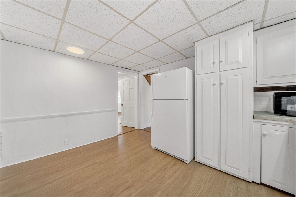 38 Longview Way Peabody, MA 01960 - Photo 8 of 42 a view of a refrigerator in kitchen and white cabinets