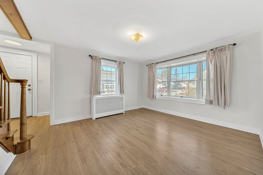 38 Longview Way Peabody, MA 01960 - Photo 9 of 42 an empty room with wooden floor and windows