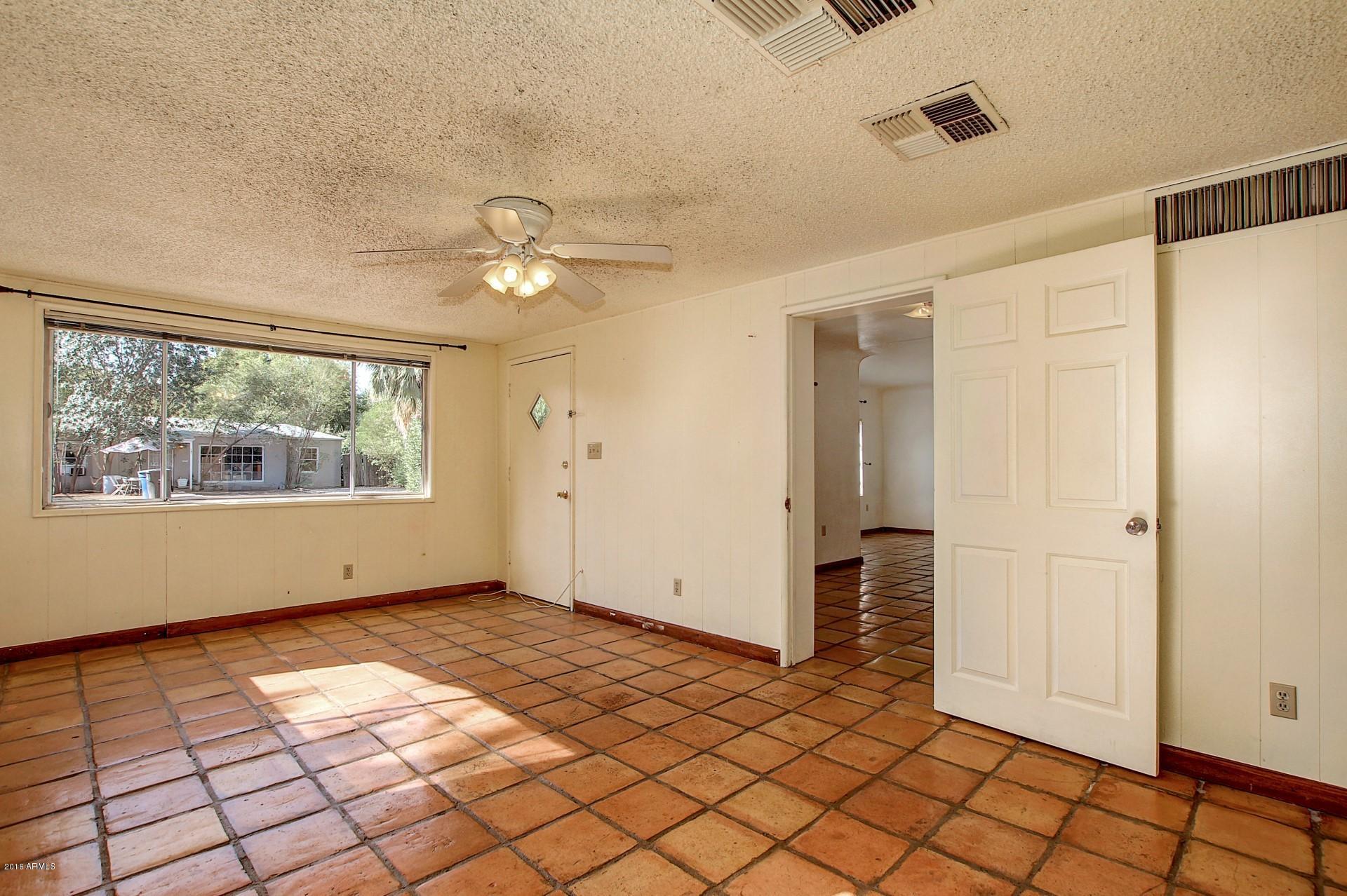 330 East 14th Street Tempe, AZ 85281 - Photo 10 of 26 a view of an empty room with window chandelier fan and fire place