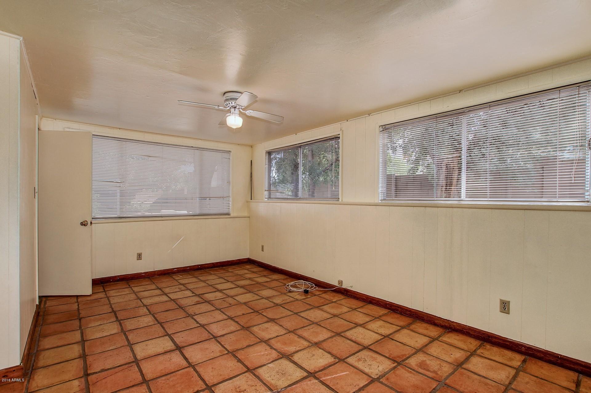 330 East 14th Street Tempe, AZ 85281 - Photo 11 of 26 a view of empty room with wooden floor and fan