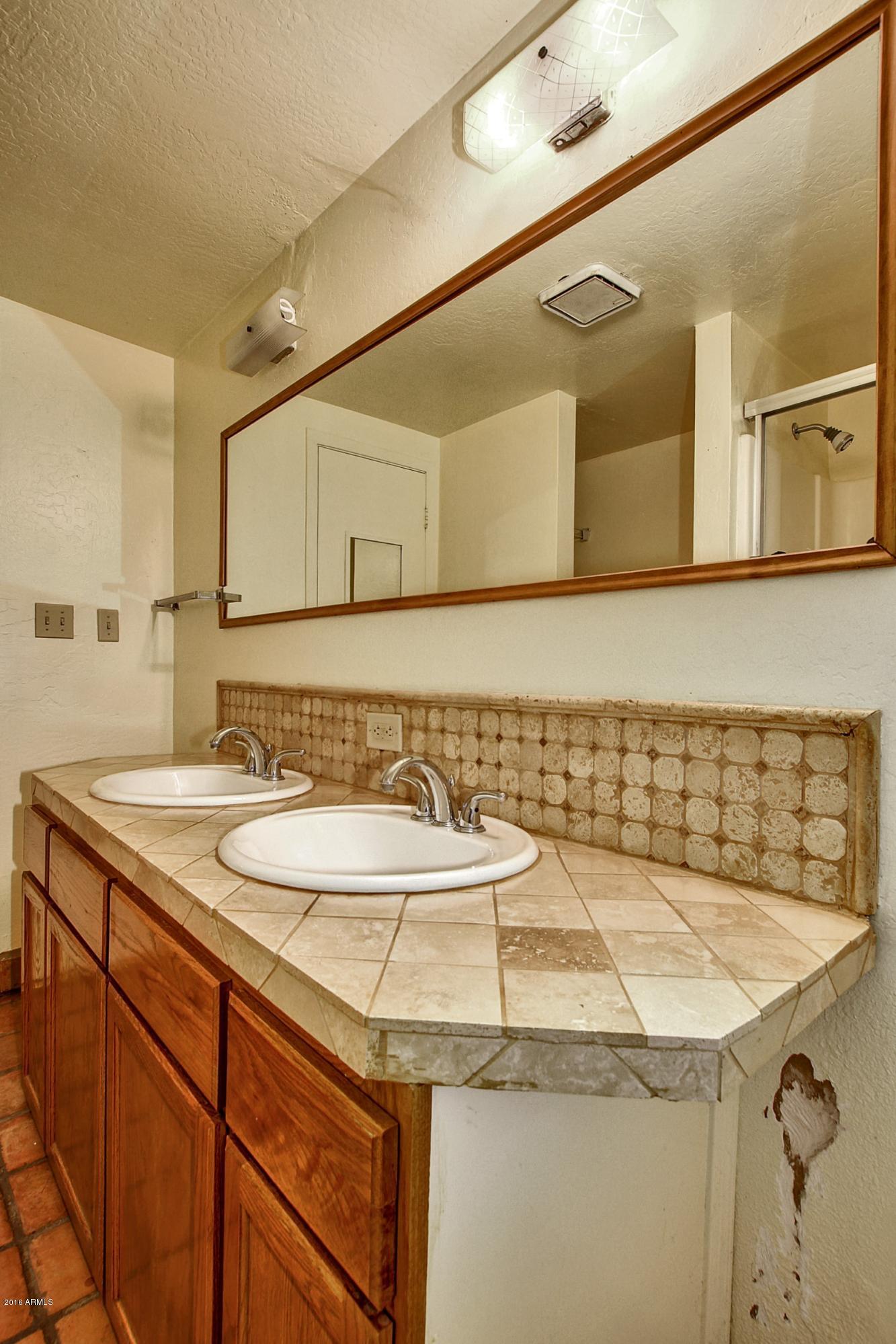 330 East 14th Street Tempe, AZ 85281 - Photo 14 of 26 a bathroom with a sink and a mirror