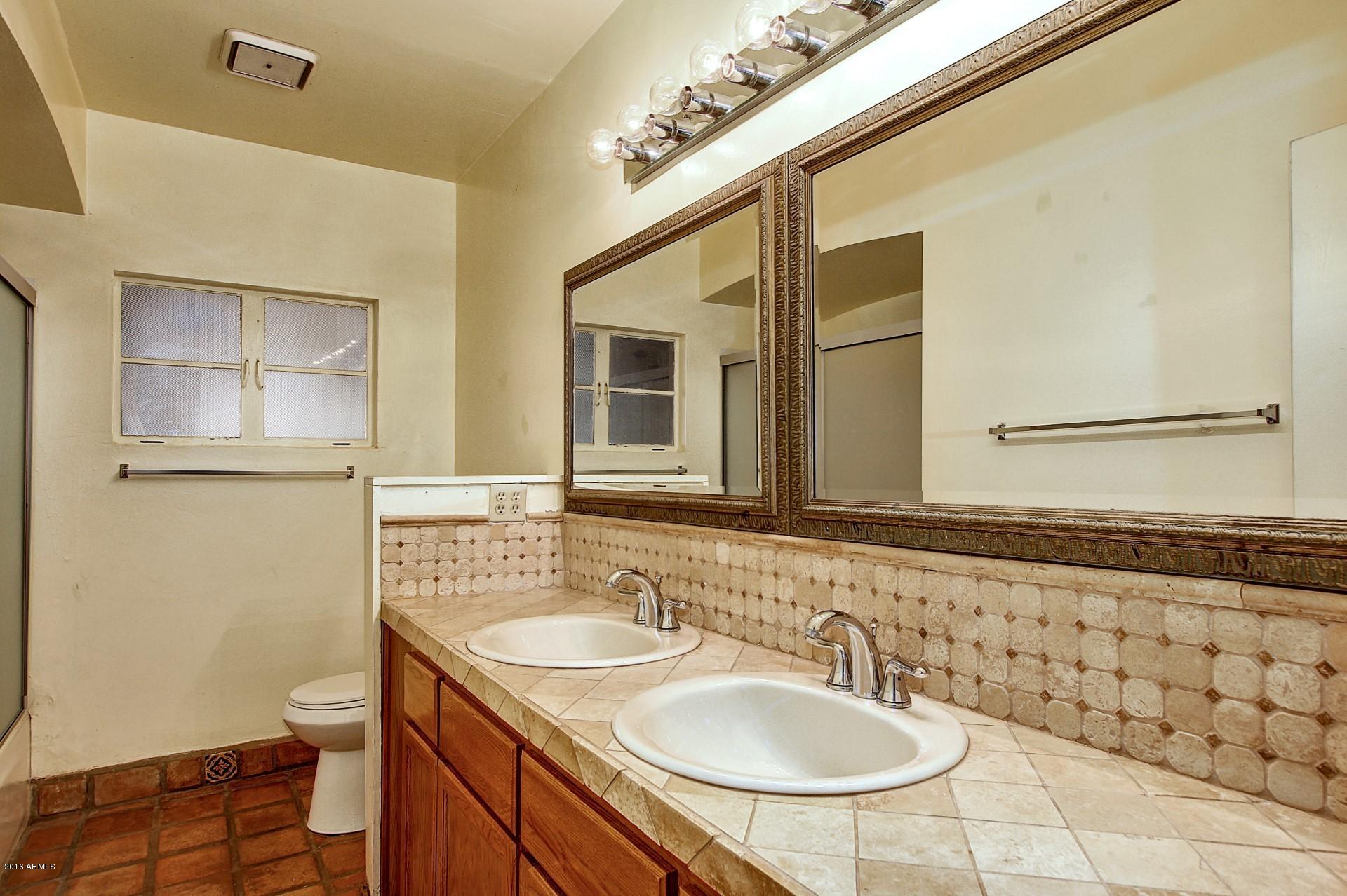 330 East 14th Street Tempe, AZ 85281 - Photo 17 of 26 a bathroom with a sink a toilet and mirror
