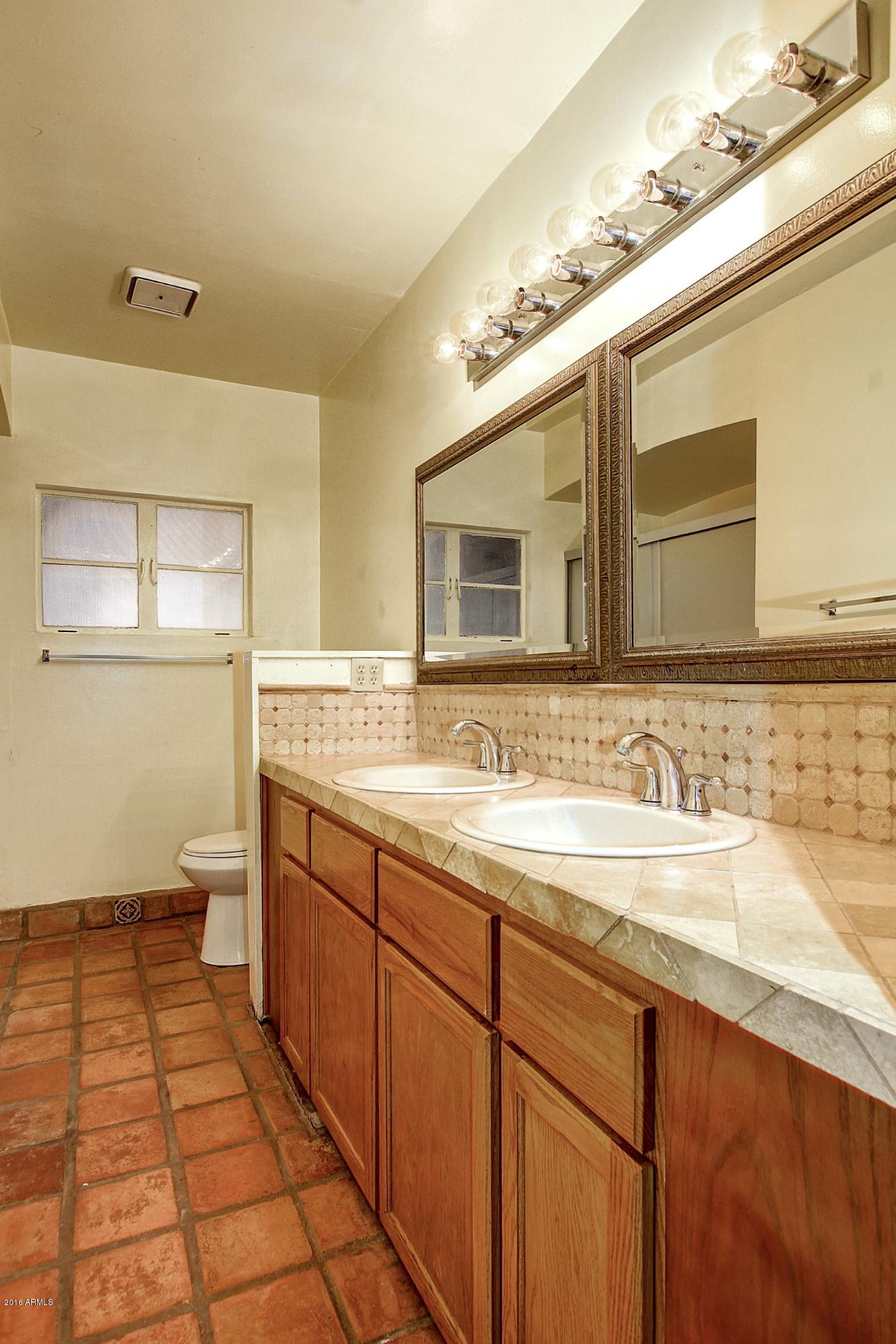 330 East 14th Street Tempe, AZ 85281 - Photo 18 of 26 a bathroom with a double vanity sink and a mirror