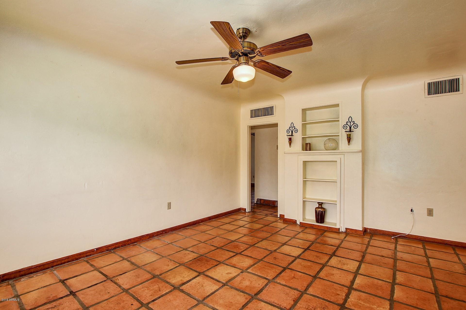 330 East 14th Street Tempe, AZ 85281 - Photo 2 of 26 a bedroom with a bed and a painting on the wall