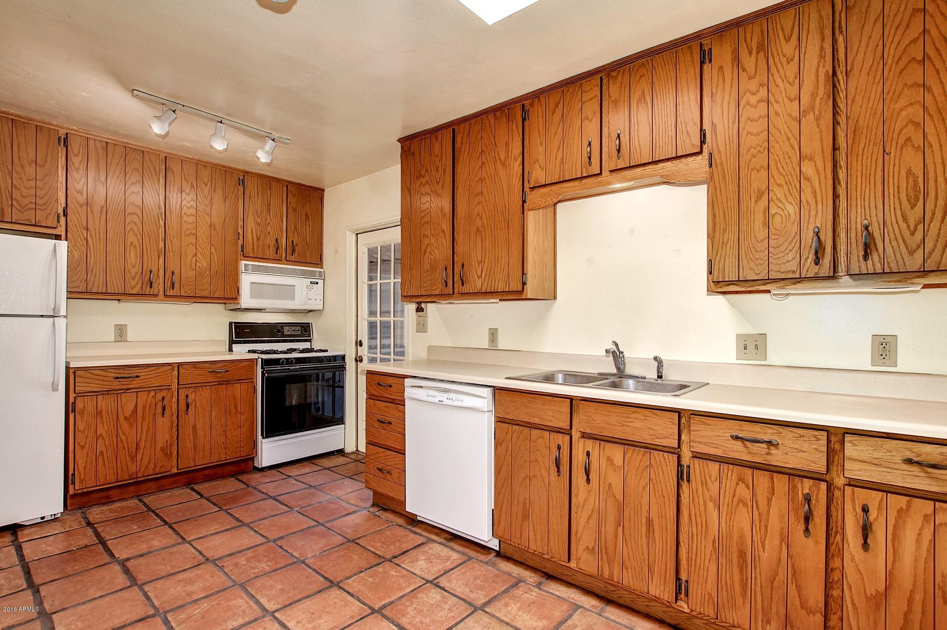 330 East 14th Street Tempe, AZ 85281 - Photo 7 of 26 a kitchen with stainless steel appliances granite countertop a stove a sink dishwasher and a refrigerator