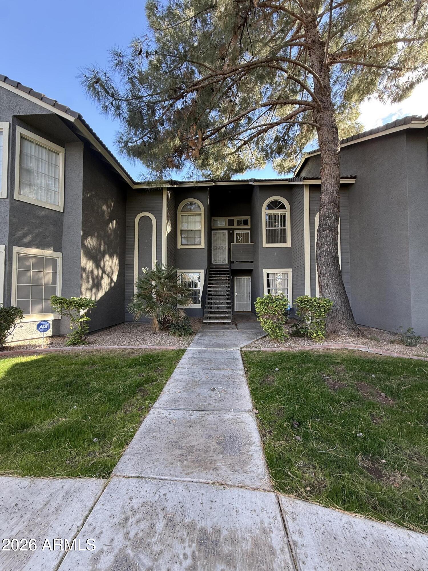 255 South Kyrene Road, Unit 140 Chandler, AZ 85226 - Photo 1 of 13 a front view of a house with a garden and trees