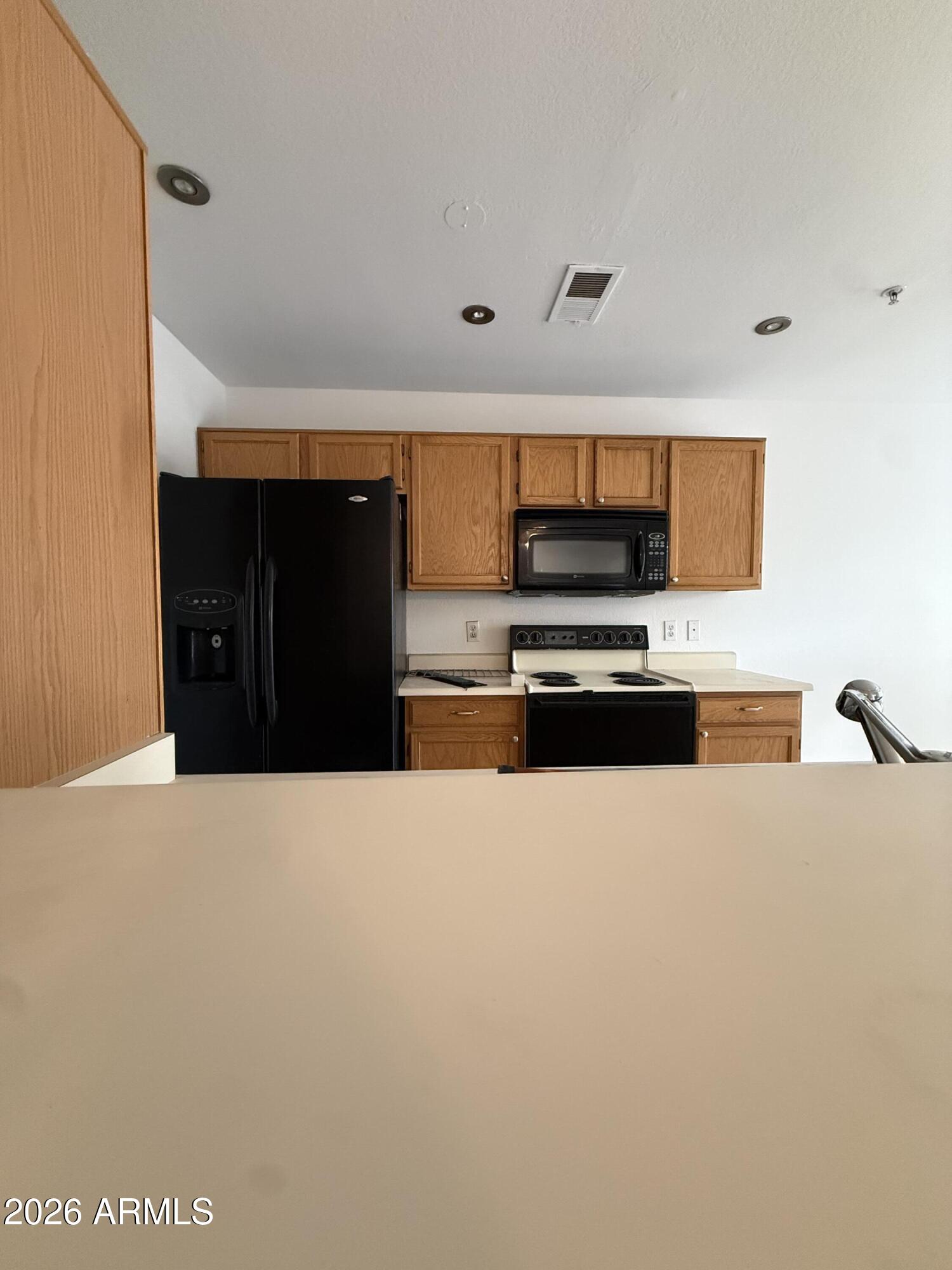 255 South Kyrene Road, Unit 140 Chandler, AZ 85226 - Photo 4 of 13 a kitchen with stainless steel appliances a refrigerator and a microwave