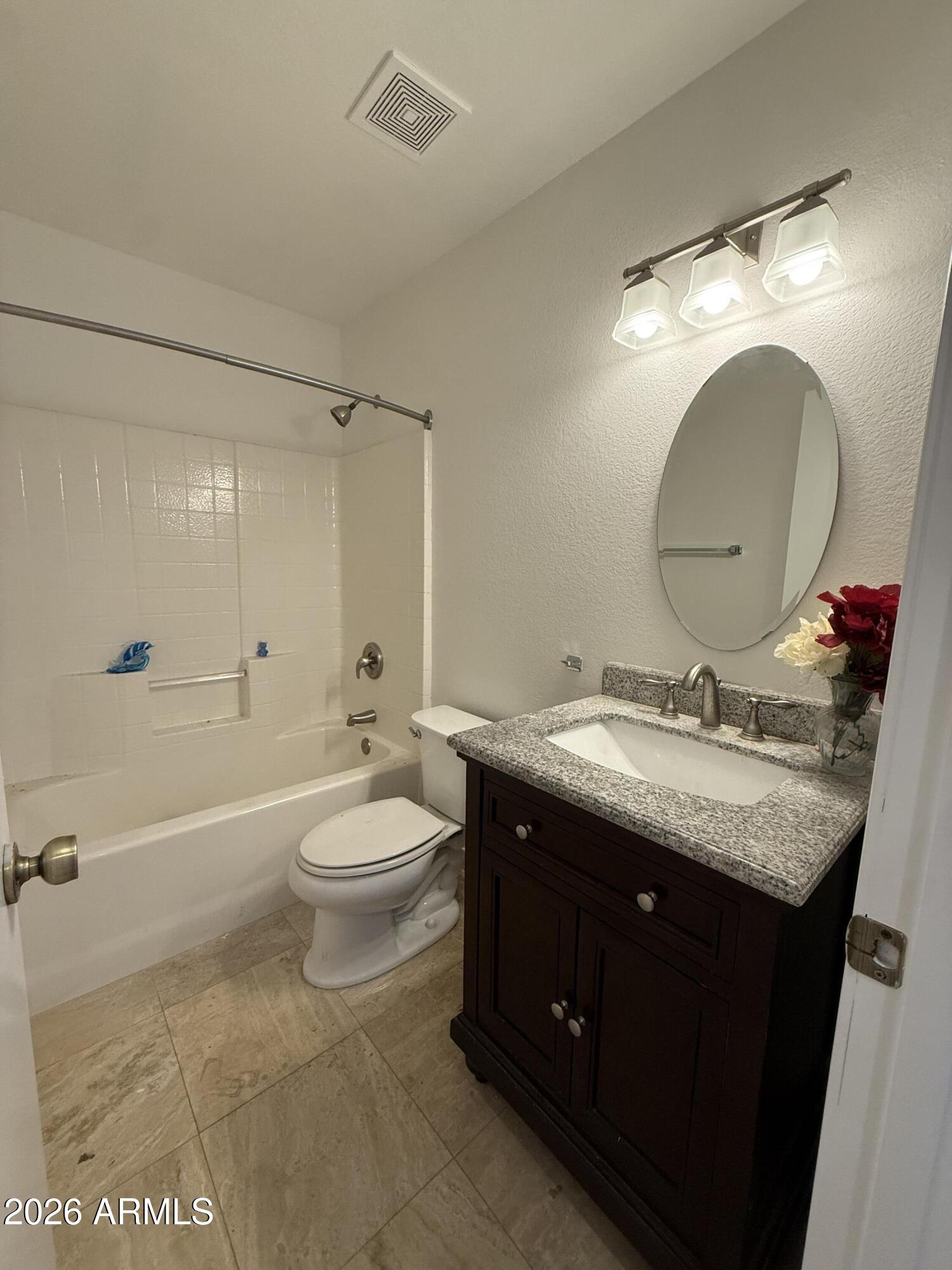 255 South Kyrene Road, Unit 140 Chandler, AZ 85226 - Photo 7 of 13 a bathroom with a granite countertop sink mirror vanity and toilet
