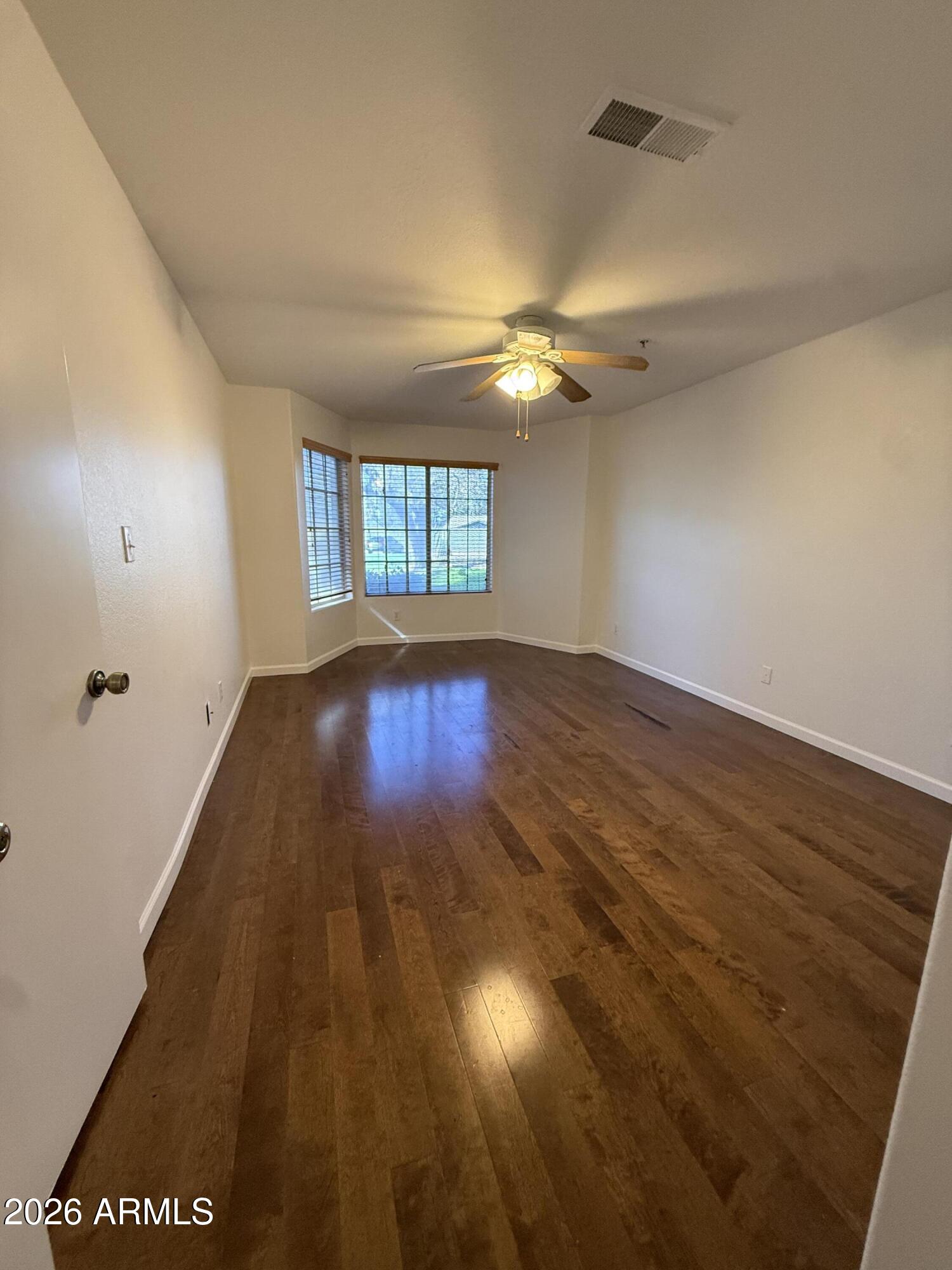 255 South Kyrene Road, Unit 140 Chandler, AZ 85226 - Photo 9 of 13 wooden floor in an empty room with a window