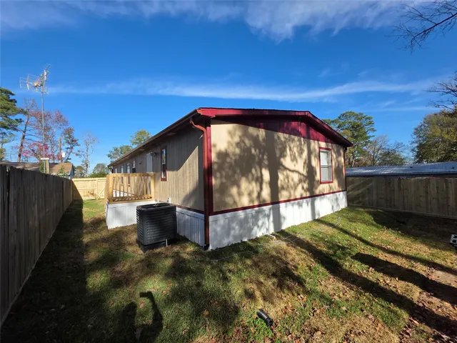 a view of backyard with swimming pool and wooden fence