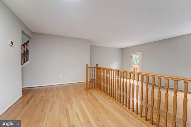 a view of a room with wooden floor