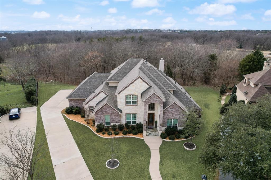 an aerial view of a house with yard porch and furniture