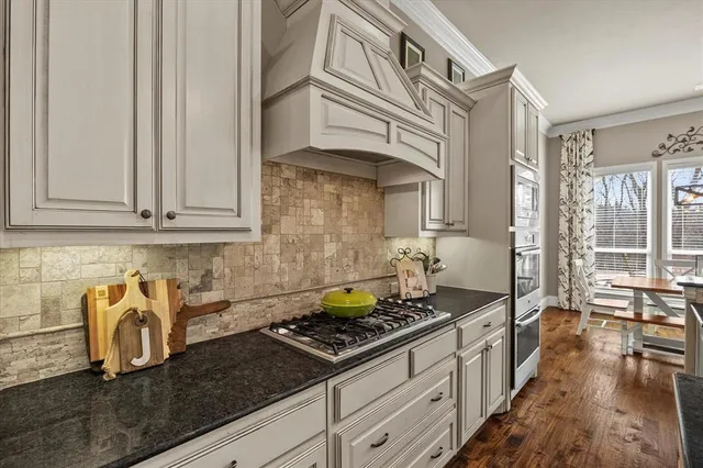 a kitchen with stainless steel appliances granite countertop a stove and a sink