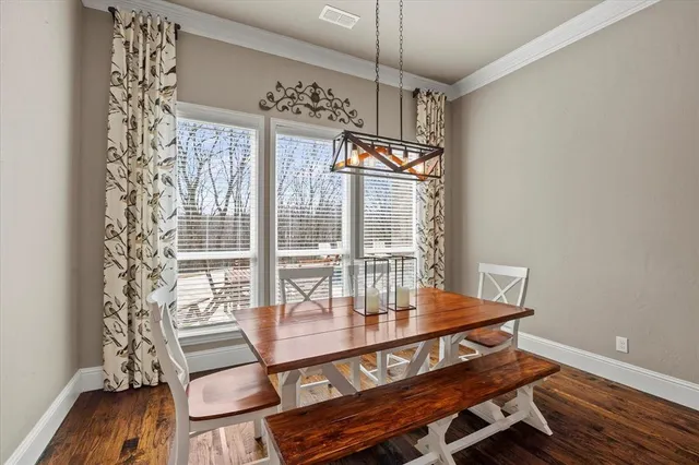 a view of a dining room with furniture wooden floor and chandelier