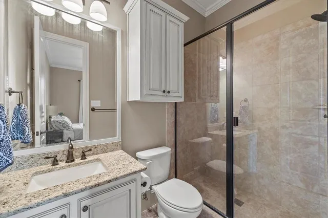 a bathroom with a granite countertop sink toilet a mirror and shower