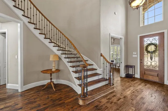 a view of entryway and hall with wooden floor