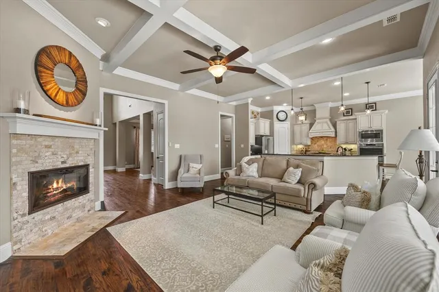 a living room with furniture a chandelier and a fireplace