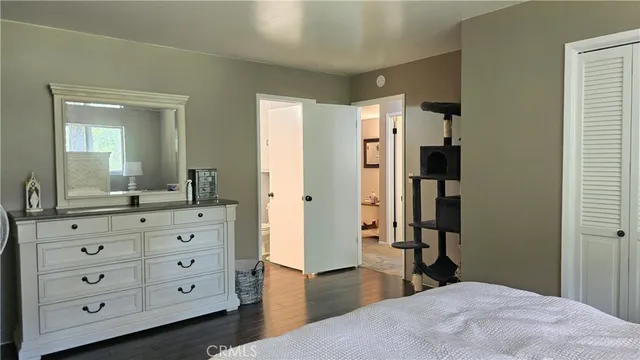 a bedroom with a bed and a dresser in it