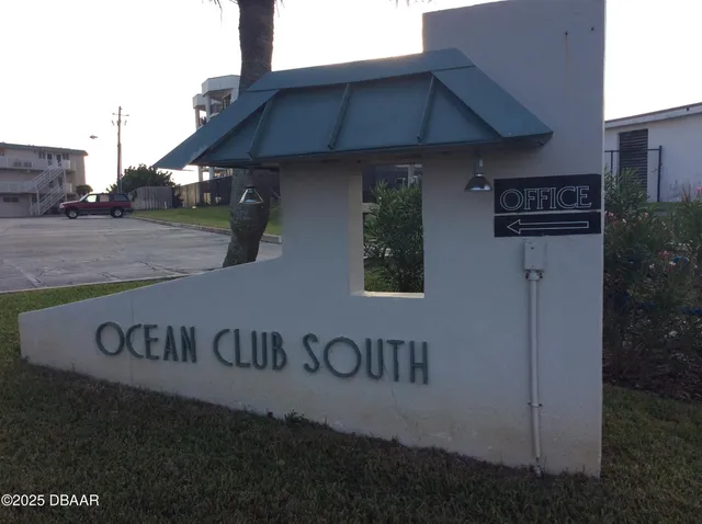a living room with furniture and a lamp