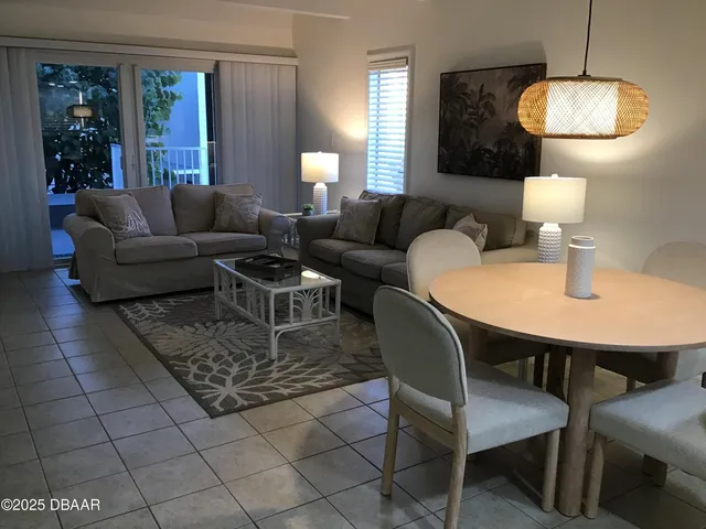a living room with furniture and a lamp