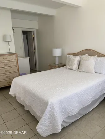 a bedroom with a bed and a lamp