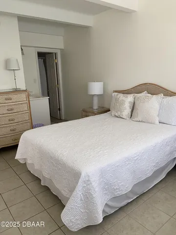 a bedroom with a bed and a lamp