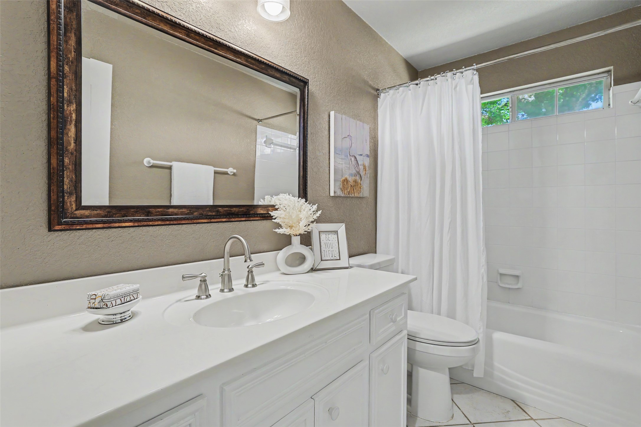 30107 Hamlet Circle Georgetown, TX 78628 - Photo 23 of 40 A well-appointed bathroom features a single vanity, a spacious mirror, and a classic tub-shower combination.