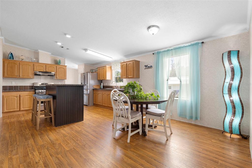 4393 Maple Avenue Edgewater, FL 32141 - Photo 12 of 41 a view of a dining room with furniture and wooden floor
