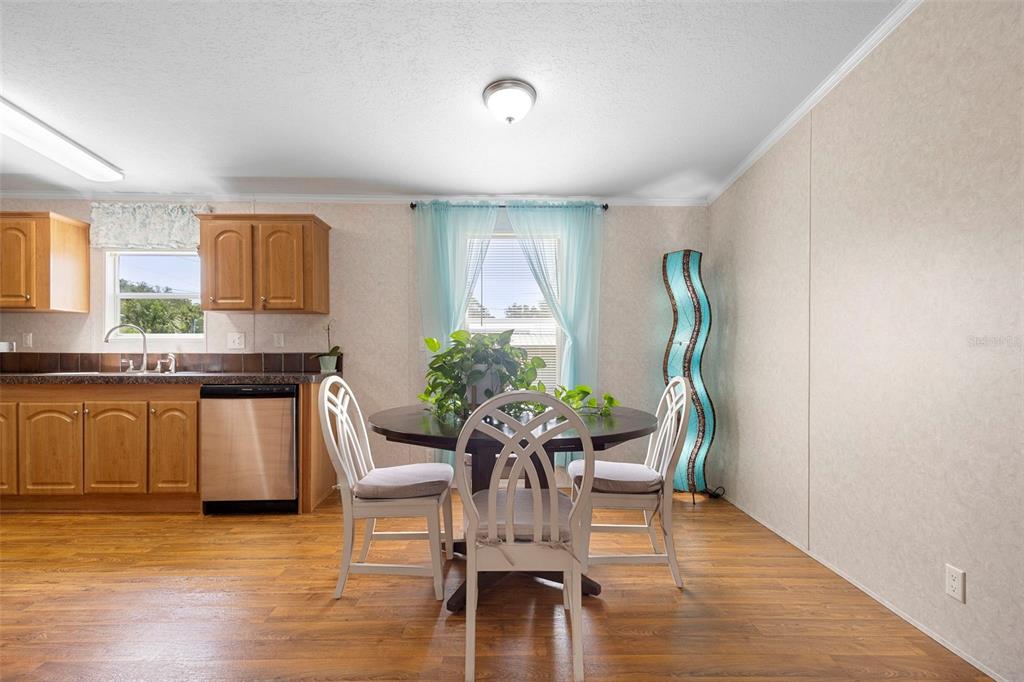 4393 Maple Avenue Edgewater, FL 32141 - Photo 13 of 41 a dining room with furniture and wooden floor