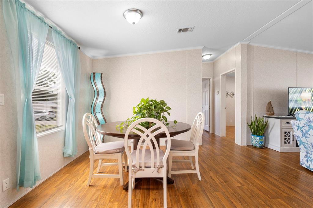 4393 Maple Avenue Edgewater, FL 32141 - Photo 15 of 41 a view of a dining room with furniture window and wooden floor