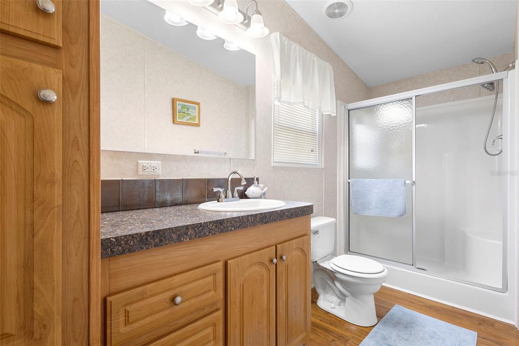4393 Maple Avenue Edgewater, FL 32141 - Photo 18 of 41 a bathroom with a granite countertop sink toilet and shower