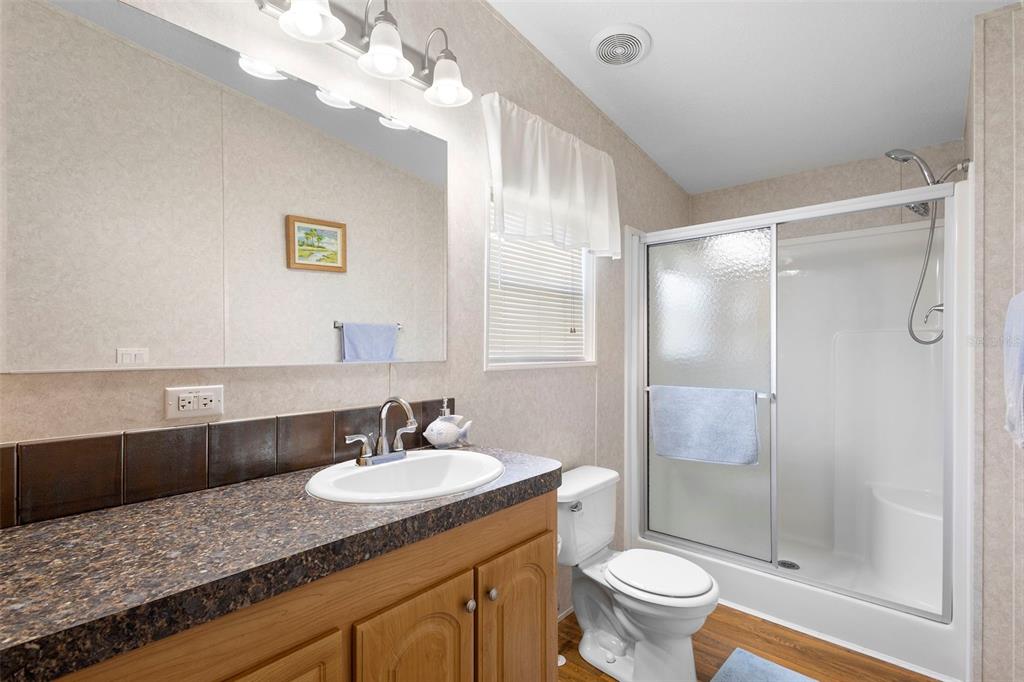 4393 Maple Avenue Edgewater, FL 32141 - Photo 19 of 41 a bathroom with a granite countertop sink toilet and shower