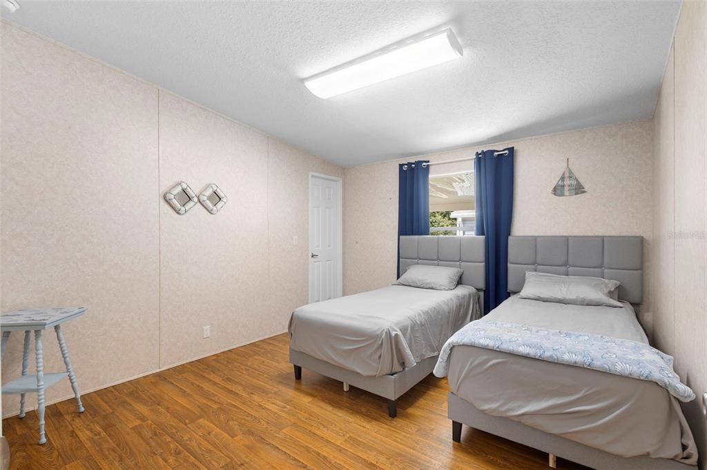 4393 Maple Avenue Edgewater, FL 32141 - Photo 22 of 41 a bedroom with two beds and painted walls