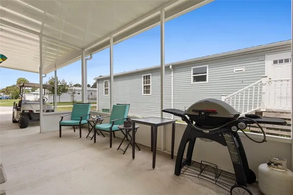 a view of a patio with table and chairs and potted plants