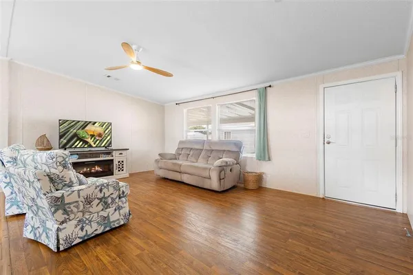 a bedroom with furniture and a wooden floor