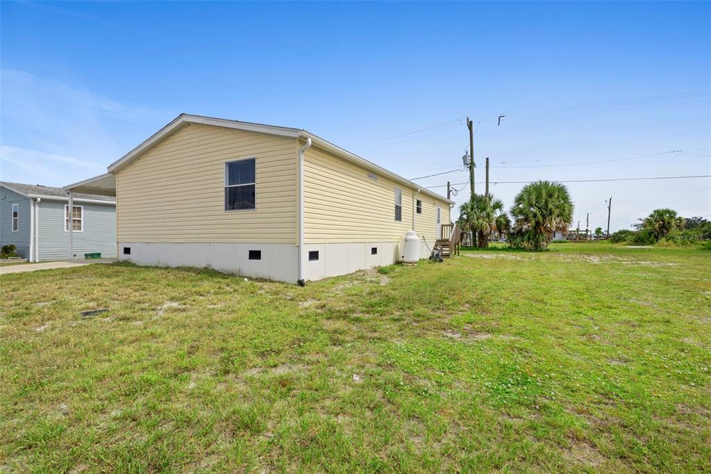 4393 Maple Avenue Edgewater, FL 32141 - Photo 39 of 41 a view of a backyard with plants and a garden