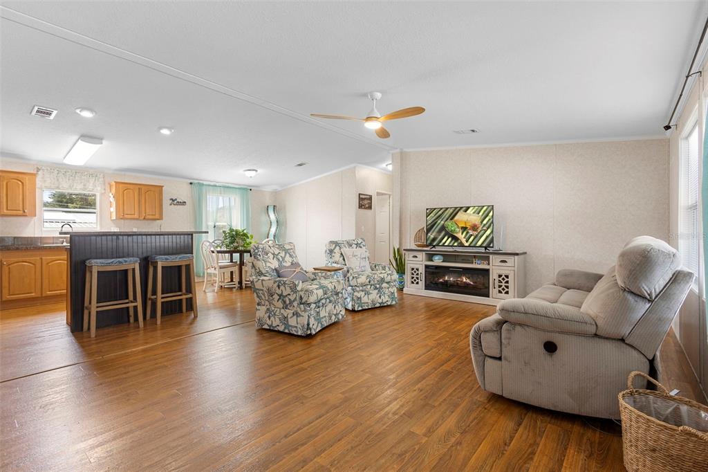 4393 Maple Avenue Edgewater, FL 32141 - Photo 5 of 41 a living room with fireplace furniture and a wooden floor
