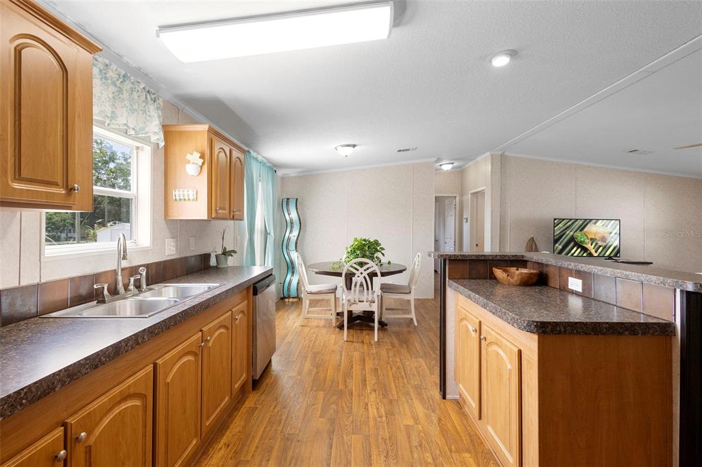 4393 Maple Avenue Edgewater, FL 32141 - Photo 10 of 41 a kitchen with granite countertop a sink stove and cabinets