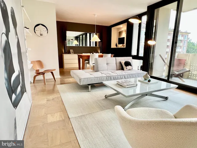 a living room with furniture fireplace and a large window