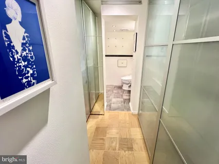 a bathroom with a granite countertop sink a toilet and a shower