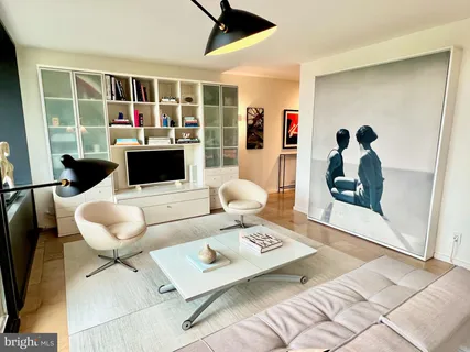 a living room with furniture and a floor to ceiling window