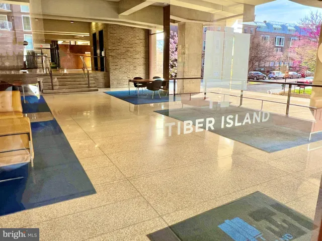a street sign on a sidewalk next to a road