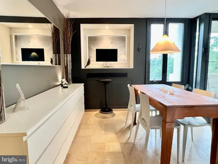 a dining room with a table and chairs