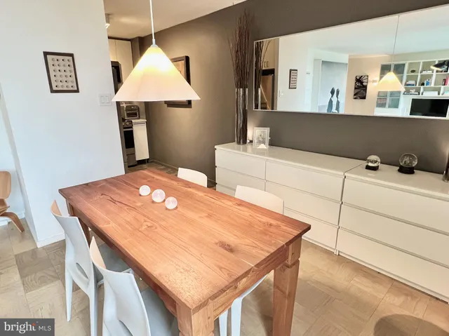 a kitchen with a table chairs and a refrigerator