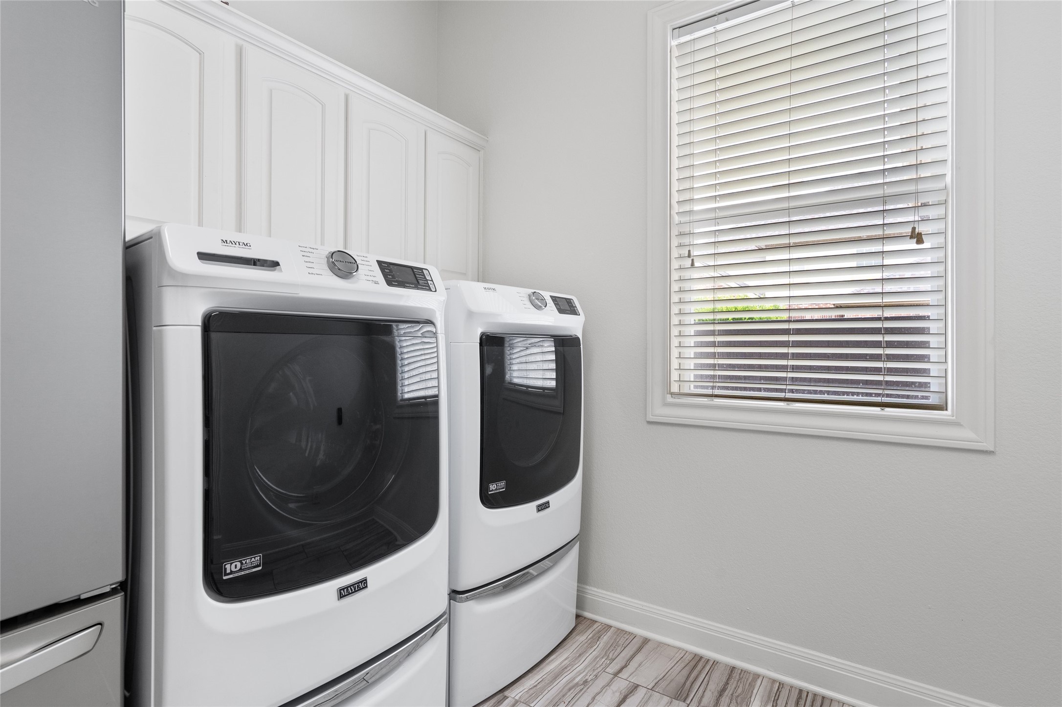 4313 Rio Robles Drive Austin, TX 78746 - Photo 18 of 40 Functional laundry room offers upper cabinetry for storage and efficient washer and dryer units.