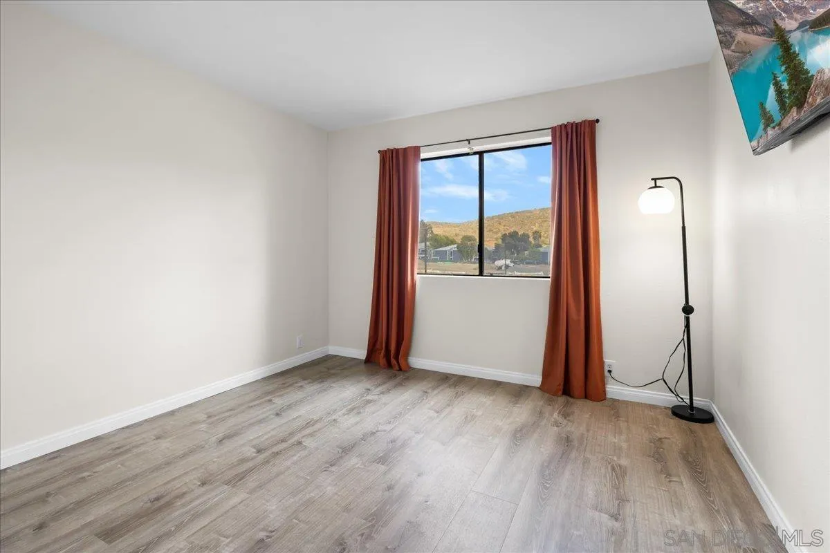 2916 Elm Tree Court Spring Valley, CA 91978 - Photo 13 of 38 an empty room with wooden floor and a window