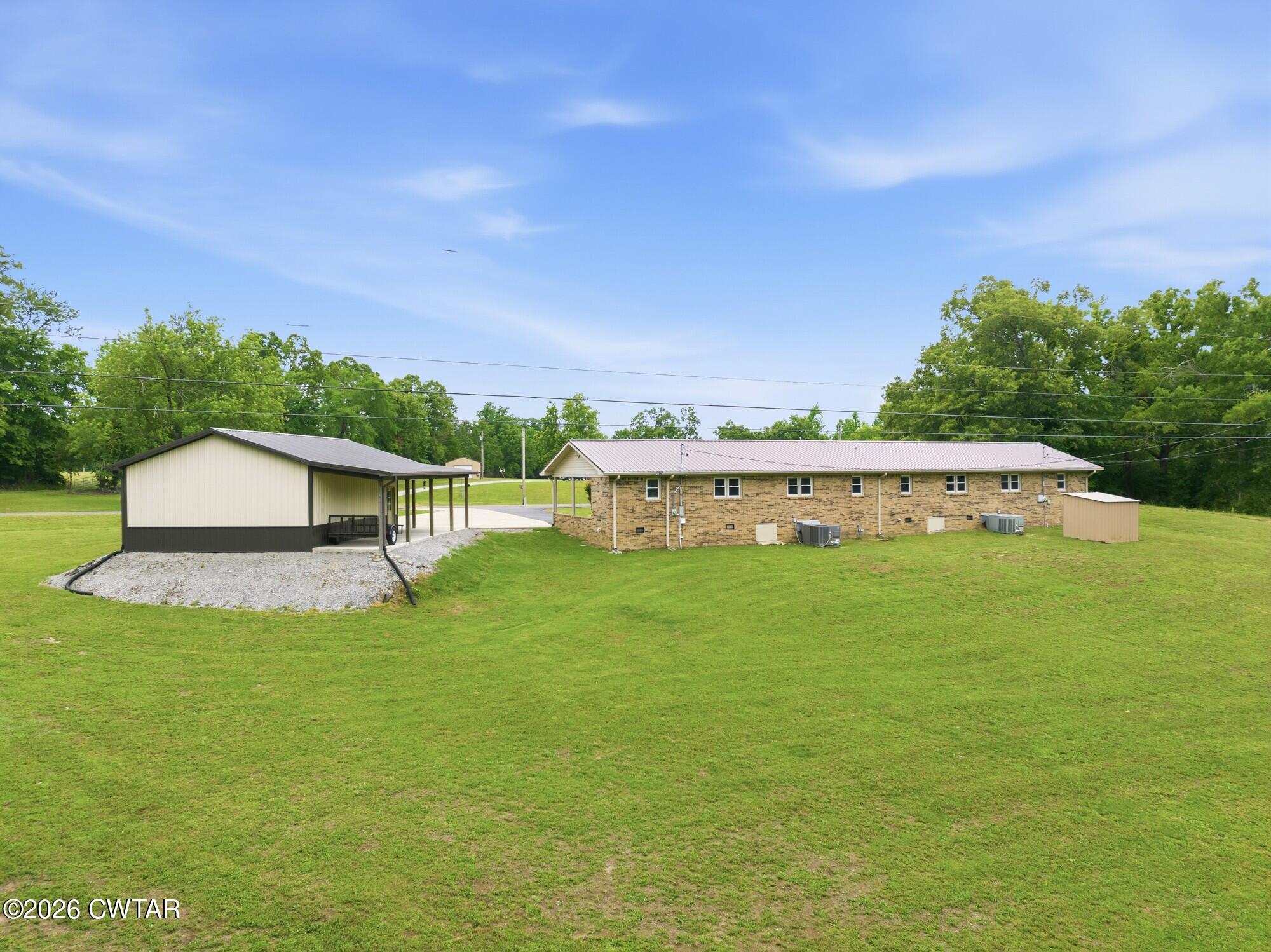 944 Brooksie Thompson Road Decaturville, TN 38329 - Photo 36 of 47 a view of a big house with a big yard plants and large trees