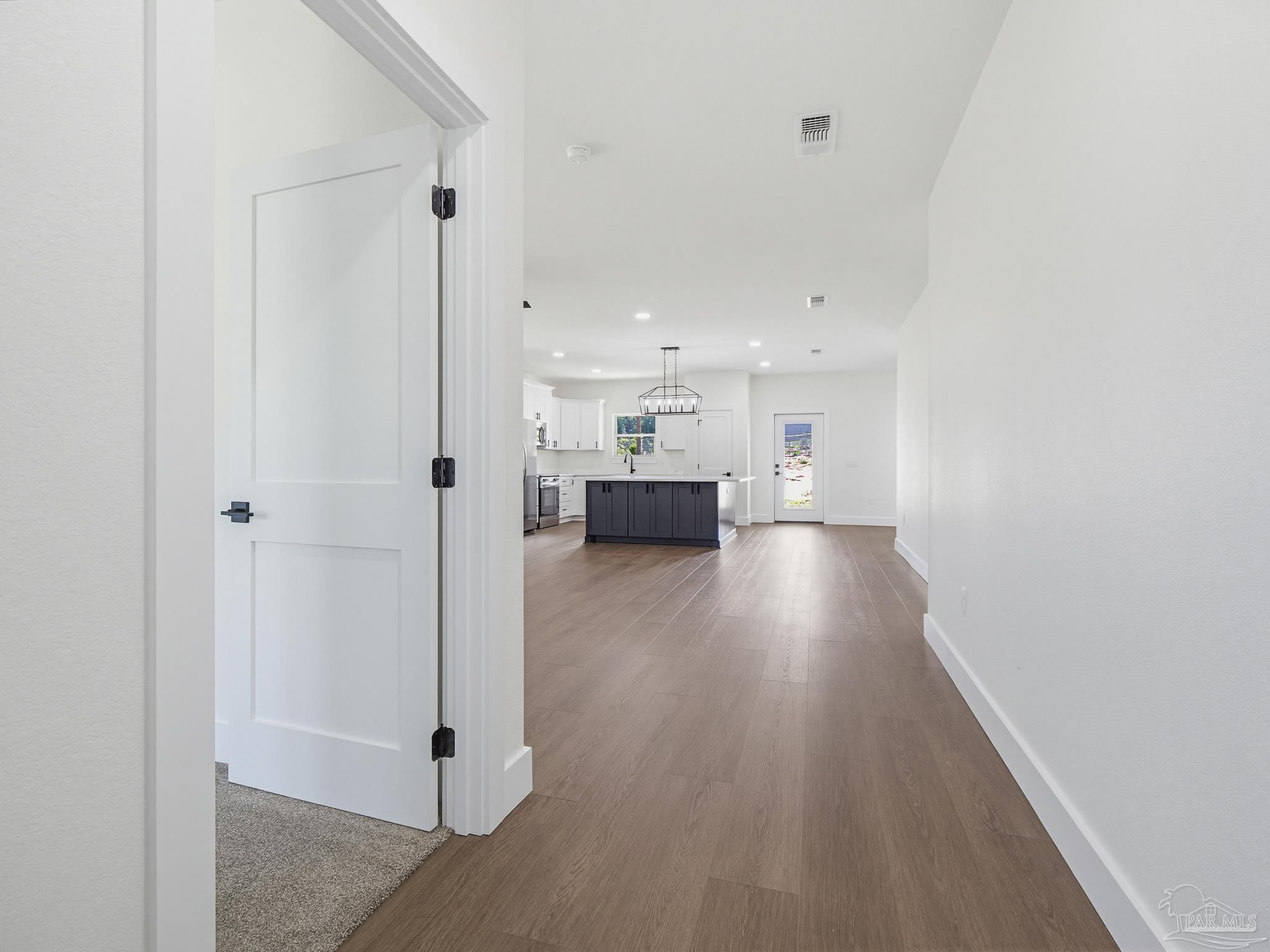 5724 Riviera Drive Milton, FL 32583 - Photo 8 of 52 a view of a hallway with wooden floor