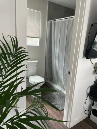 a bathroom with a toilet a sink and a mirror