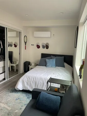 a bedroom with a bed and window